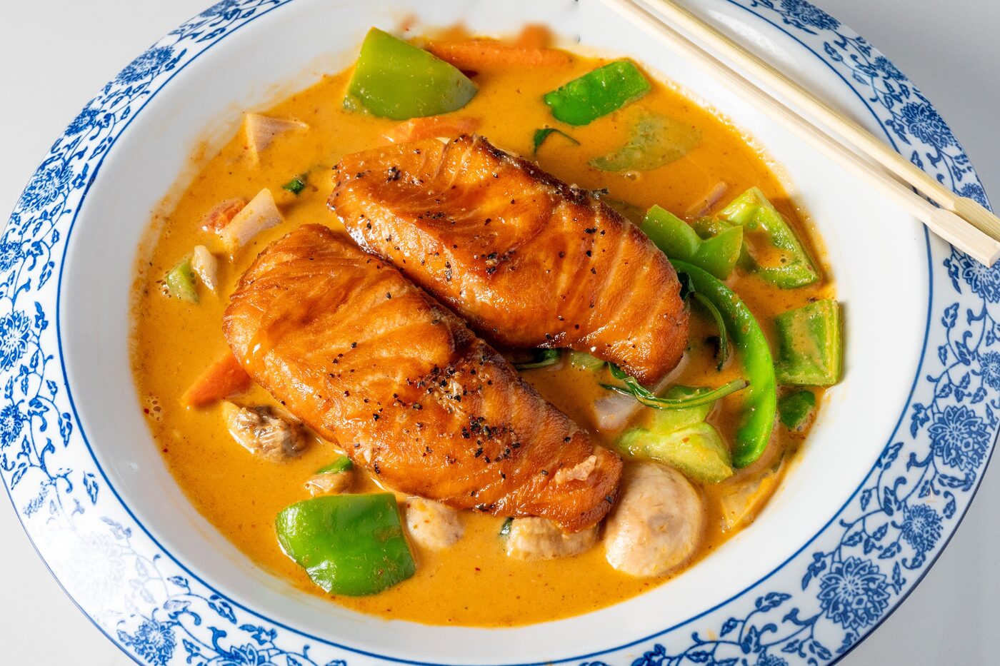 King Salmon served in Thai red curry sauce - East Moon Asian Bistro Centennial
