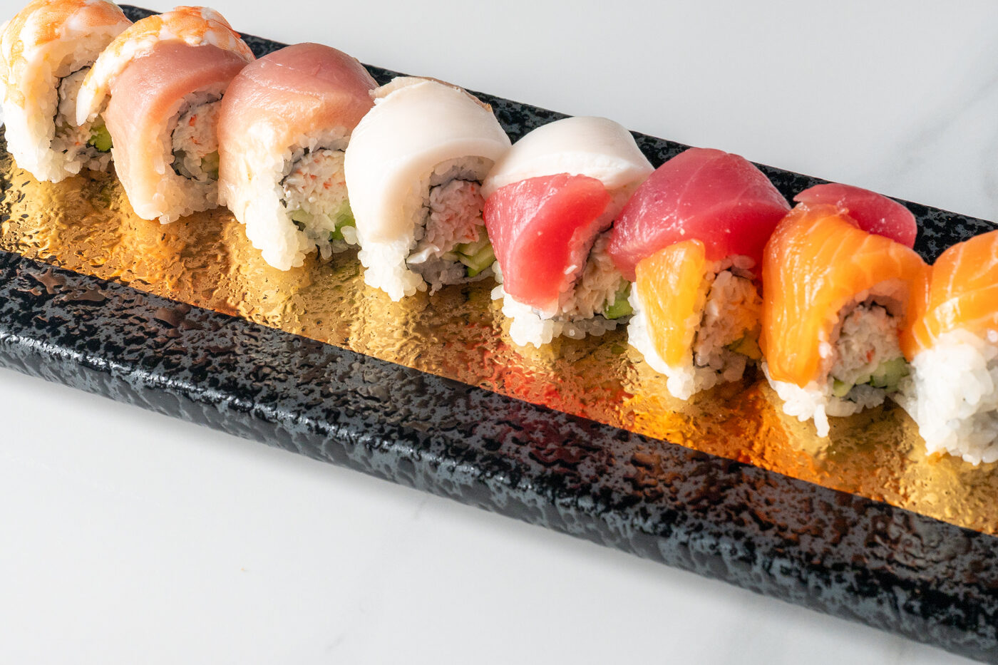 Rainbow Roll topped with tuna, salmon and yellowtail - East Moon Asian Bistro Centennial CO
