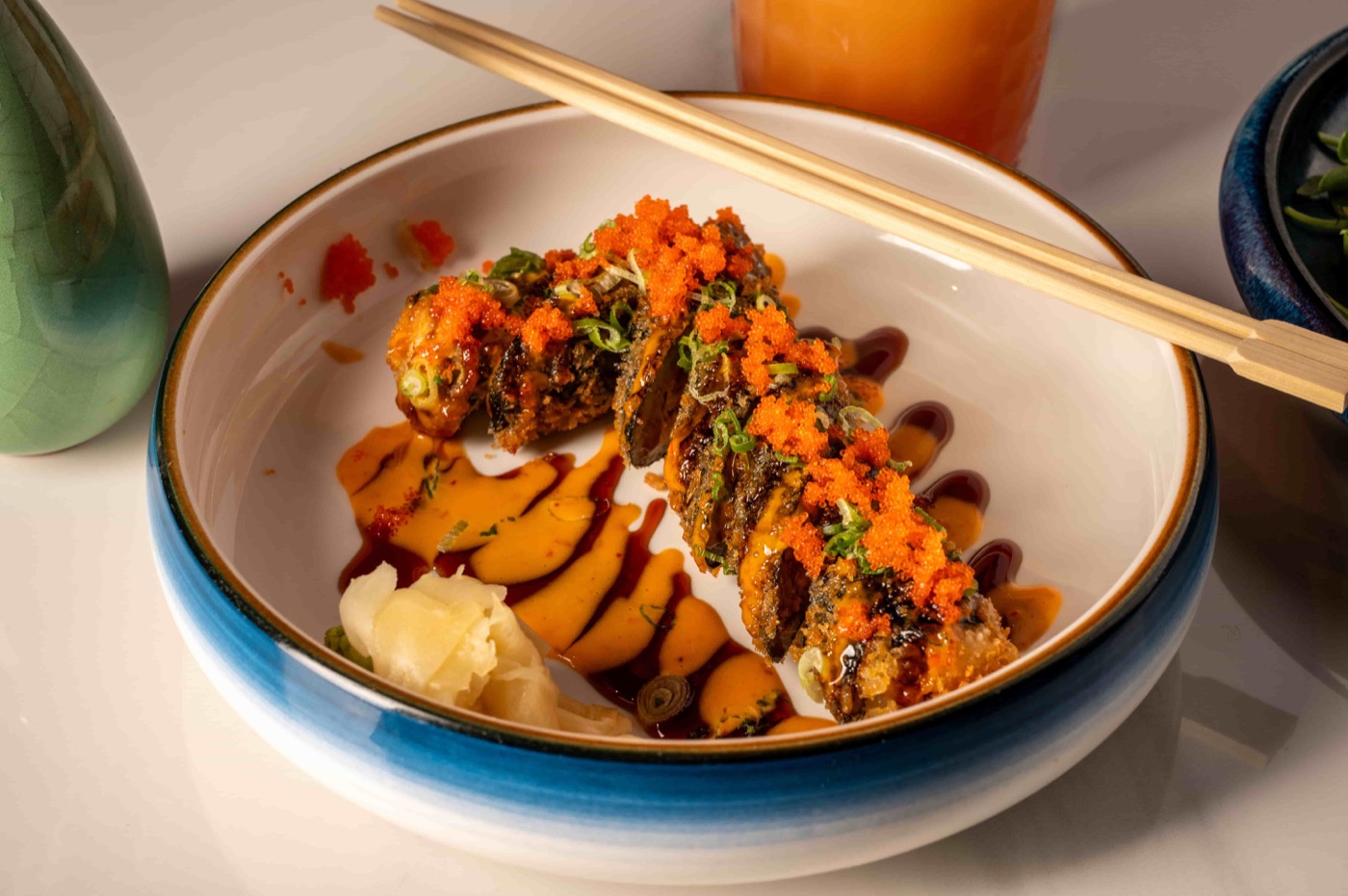 Lucky 7 Roll deep fried spicy tuna and avocado roll topped with flying fish roe - East Moon Centennial CO