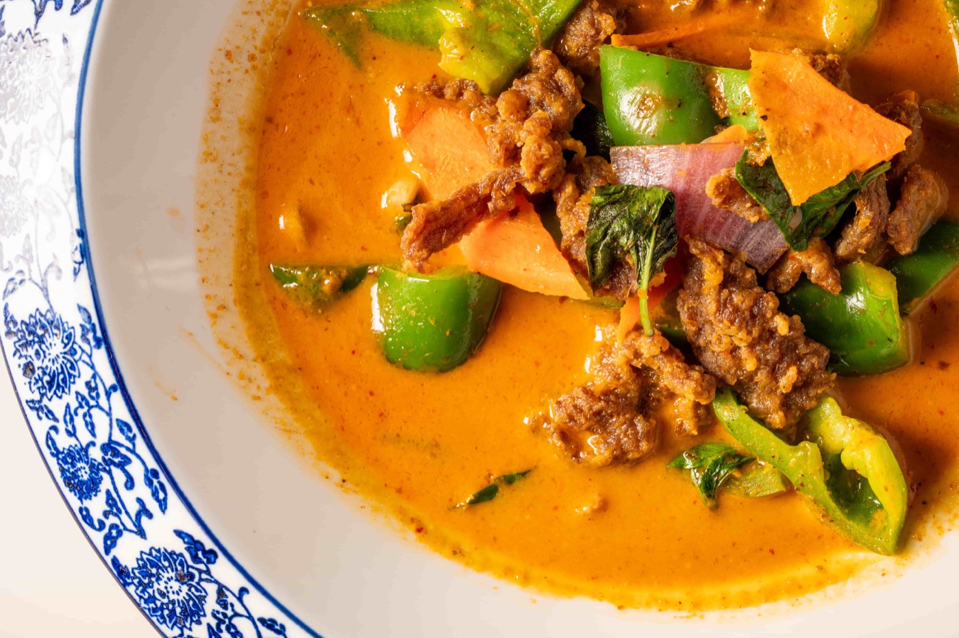 Panang red curry slow cooked with coconut milk, kaffir lime leaves, basil and sweet potato - East Moon Centennial CO