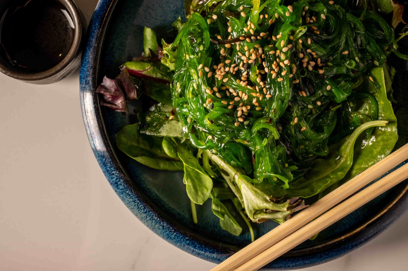 Seaweed salad with toasted sesame seeds over mixed greens - East Moon Asian Bistro Centennial CO