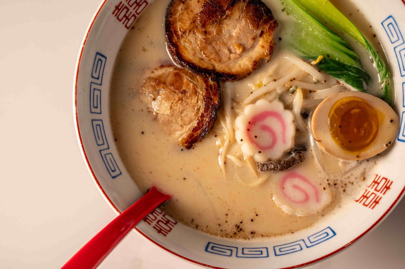 Tonkatsu ramen with marinated pork belly, soft boiled egg and bok choy - East Moon Asian Bistro Centennial CO